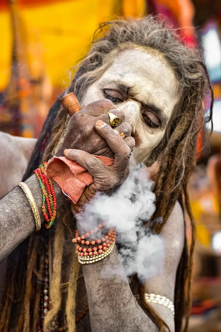 A sadhu in India smokes a chillum—a famous smoking pipe in global stoner culture.